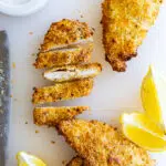 Air Fryer Chicken Cutlets with lemon wedges.