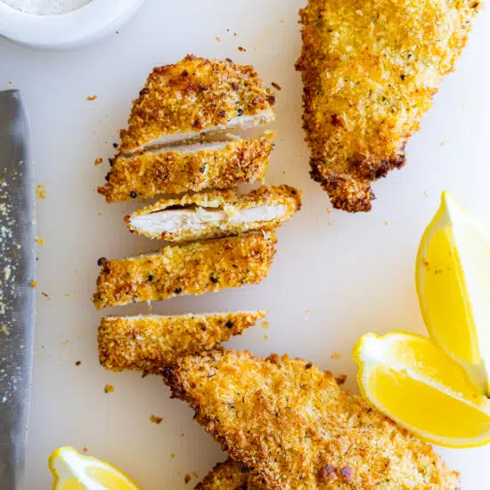 Air Fryer Chicken Cutlets with lemon wedges.