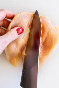 Chicken breasts sliced in half.