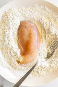 Chicken cutlet coated in seasoned flour.