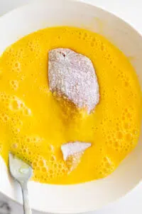 Chicken cutlet in beaten egg.
