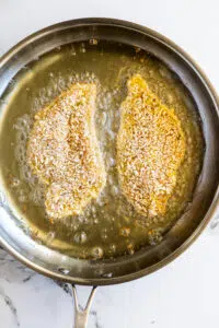 Breaded Chicken Cutlets frying in oil.