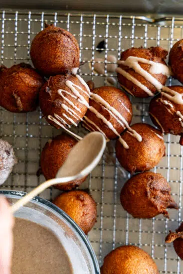 Applesauce fritters drizzled with cinnamon glaze.
