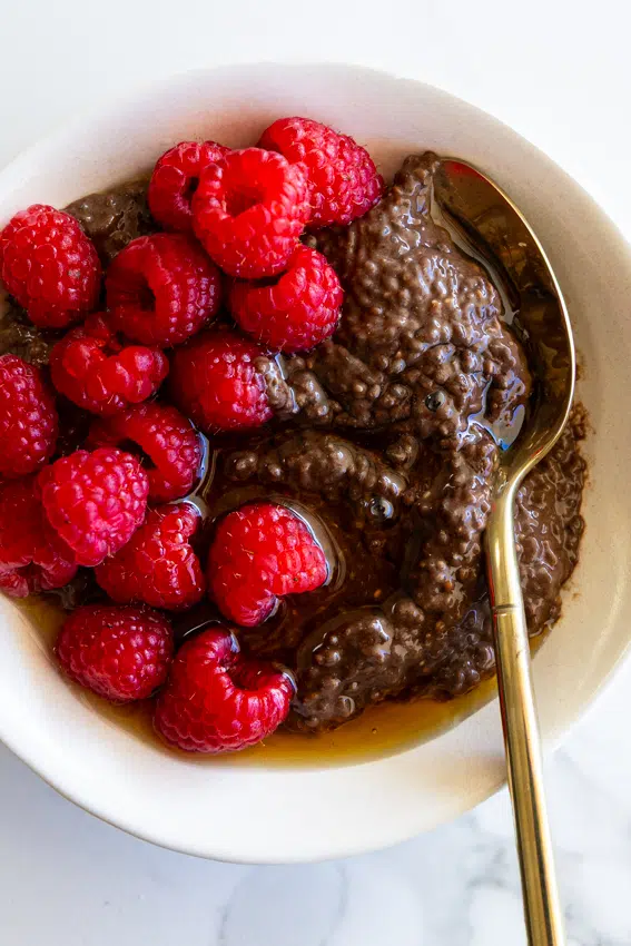 Chocolate chia pudding served with fresh raspberries.