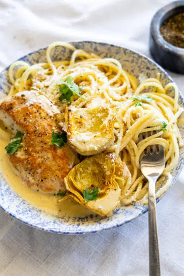 Chicken Artichoke Pasta in blue and white bowl.