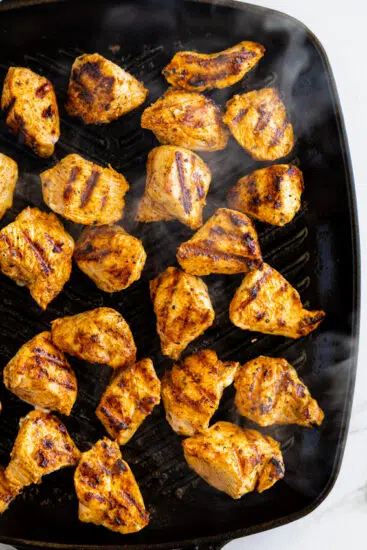 Grilled chicken nuggets in a grill pan.