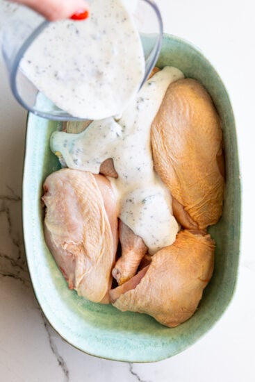 Buttermilk marinade poured over chicken.