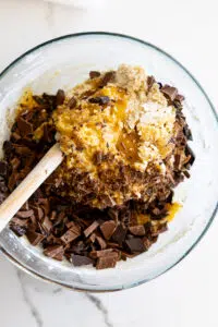 Chocolate chunks added to cookie batter.