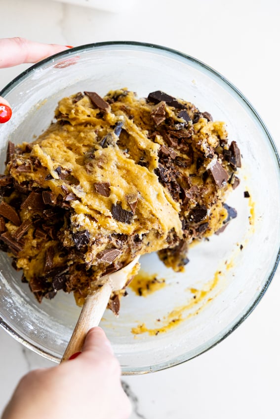 Chocolate chunk cookie dough stirred together.