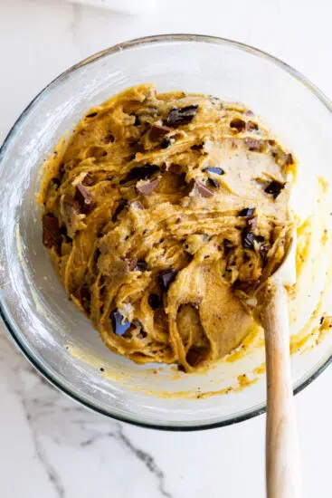 Chocolate Chunk Cookie dough in a glass mixing bowl.