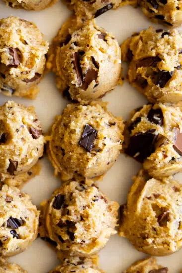 Chocolate Chunk Cookie batter scooped out onto a cookie sheet.