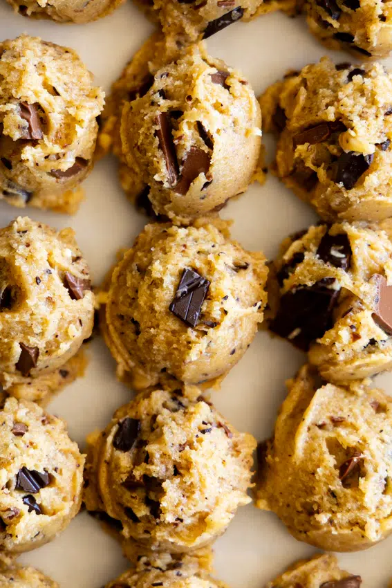 Chocolate Chunk Cookie batter scooped out onto a cookie sheet.