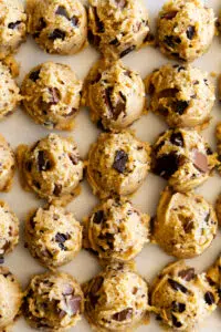 Chocolate Chunk Cookie dough scooped onto a cookie sheet.