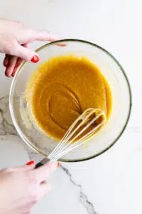 Wet ingredients for cookie batter in a glass bowl.