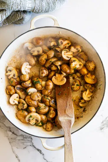 Mushrooms sautéing for mushroom gravy.