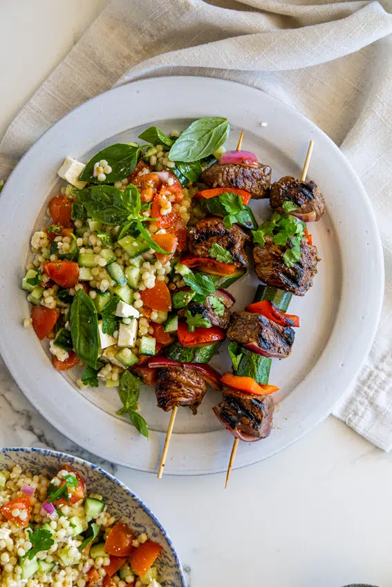 Pearl Couscous Salad served with steak kebabs.