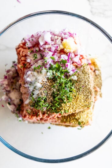 Seasoned ground lamb in glass bowl.