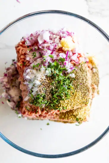 Seasoned ground lamb in glass bowl.