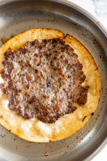 Smashed lamb wraps in pan.