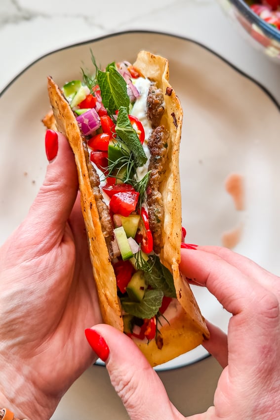 Easy Smashed Lamb Wraps with chopped salad and yogurt sauce.