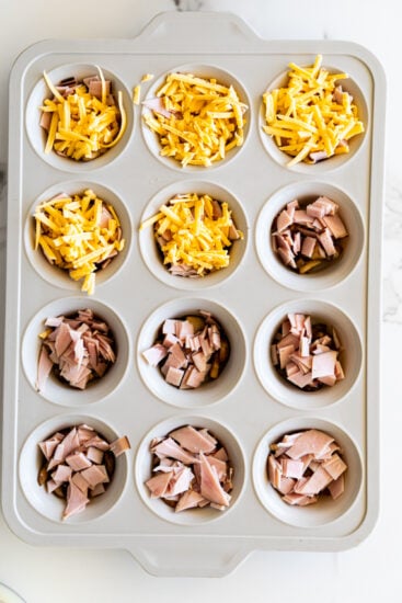 Cheddar cheese in muffin pan for egg bites.