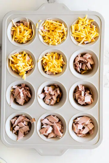 Cheddar cheese in muffin pan for egg bites.