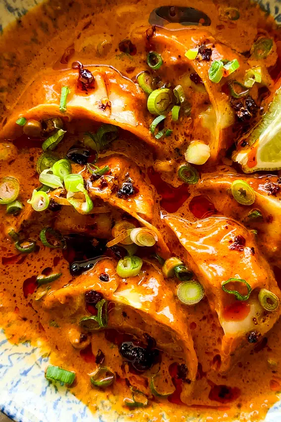 Frozen dumplings cooked in coconut broth.