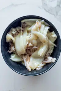 Seasoned calamari in bowl.