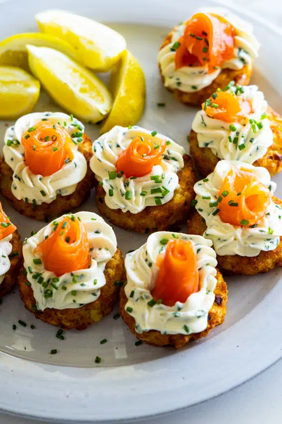Close up of smoked salmon rose on cream cheese hashbrown bite.