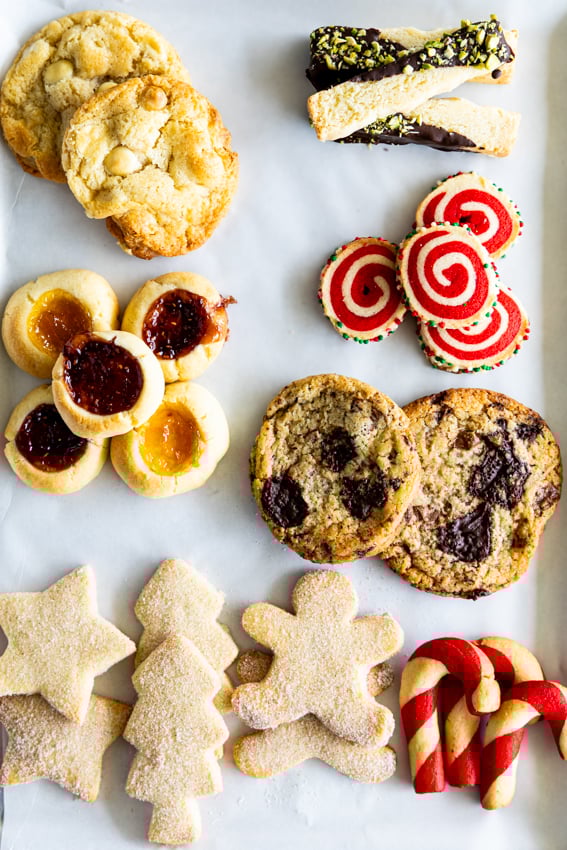 Seven varieties of Christmas cookies on a cookie sheet.