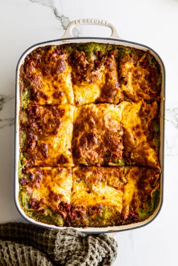 Baked Christmas lasagna in casserole dish with golden cheese top.
