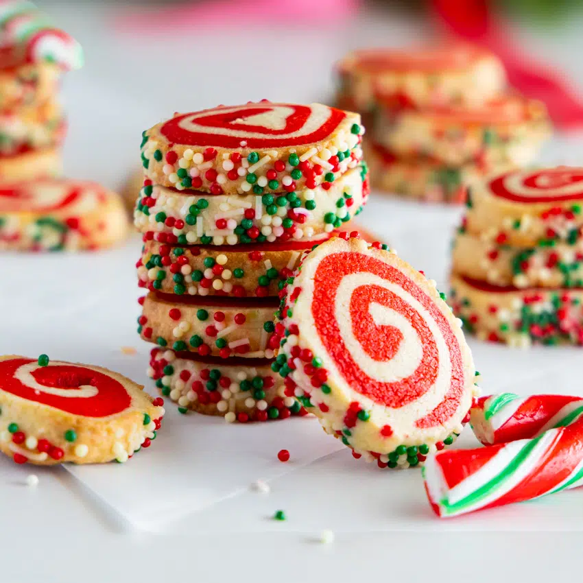 Festive pinwheel cookies stacked.