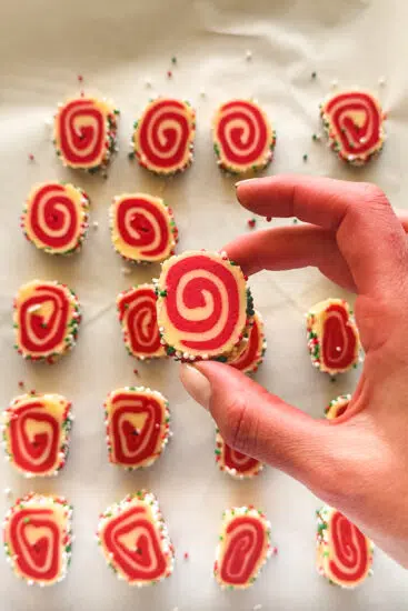 Sliced pinwheel cookies on a baking sheet lined with parchment paper.