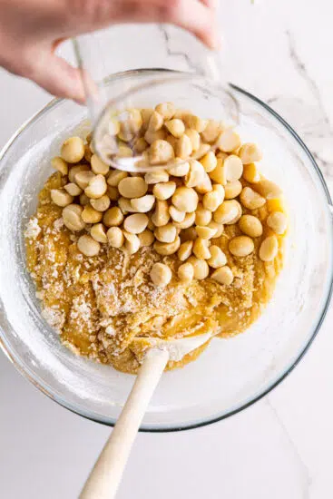 Macadamia nuts and white chocolate stirred into cookie dough.