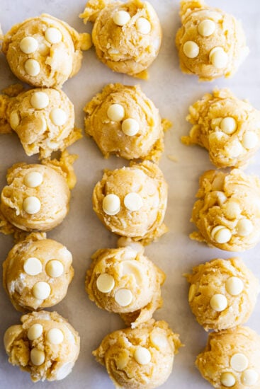White Chocolate Macadamia Cookies scooped and placed onto lined baking sheets to chill.