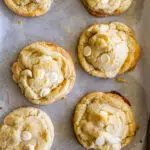 Close up of white chocolate macadamia cookie with melted chocolate chunks.