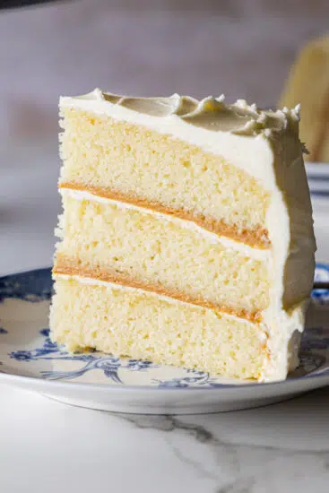 A perfect slice of vanilla cake on a serving plate.
