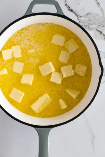 Butter melting slowly in a pan.
