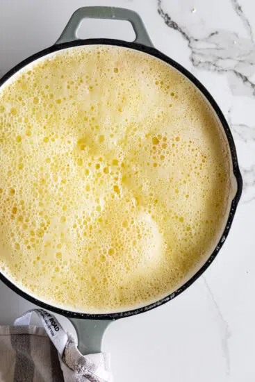 Butter foaming while cooking.