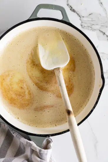 Butter starting to brown in frying pan.