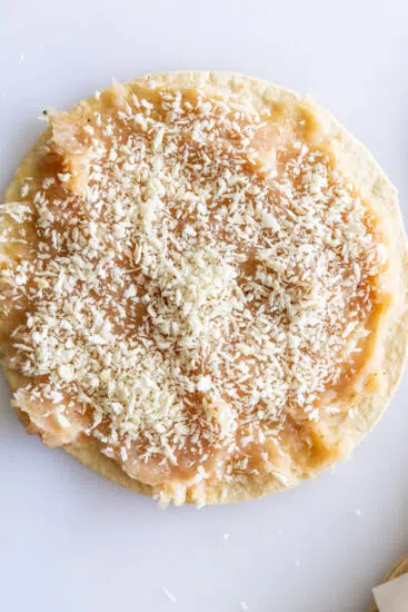 Panko breadcrumbs pressed onto ground chicken.