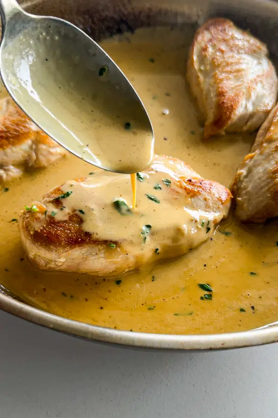 Dijon cream sauce spooned over chicken