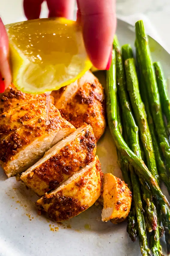 Lemon drizzled over chicken breast.