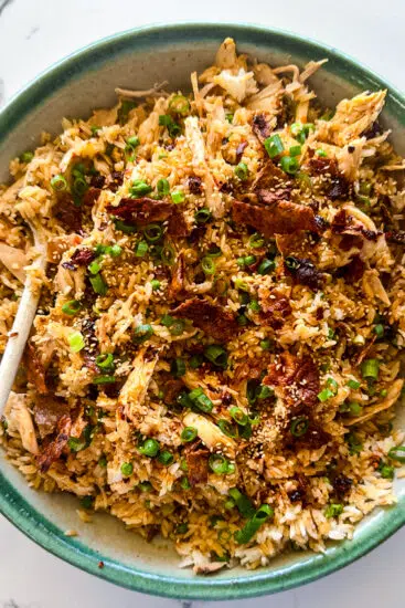 Viral Rotisserie Chicken Rice topped with crispy chicken skin and scallions.