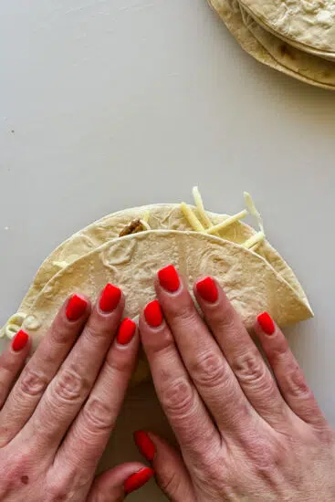 Soft tortillas filled with taco meat and cheese folded over.