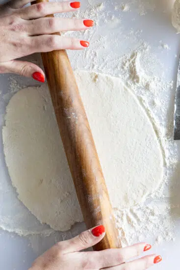 Cottage cheese tortilla rolled out with wooden rolling pin.