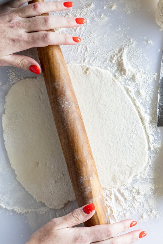 Cottage cheese tortilla rolled out with wooden rolling pin.