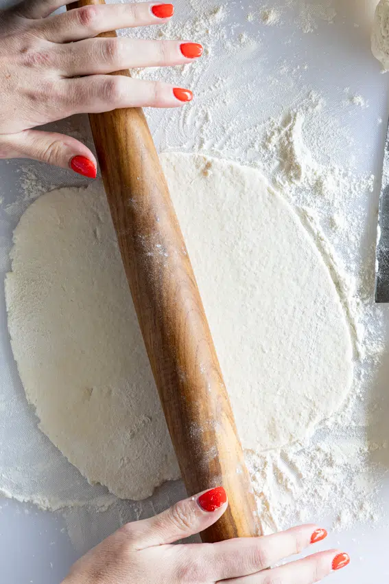 Cottage cheese tortilla rolled out with wooden rolling pin.