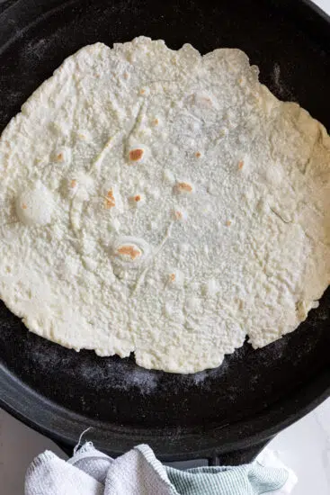 Cottage cheese tortilla cooked in hot pan.
