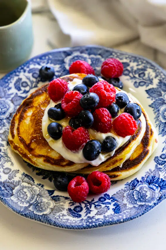 Cottage cheese pancakes served with berries and yogurt.